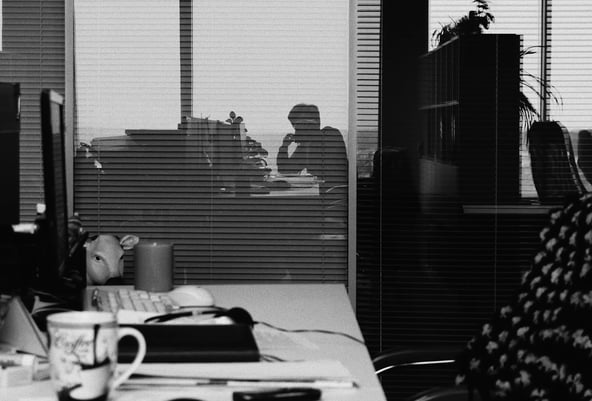reflection in office glass of solitary finance worker