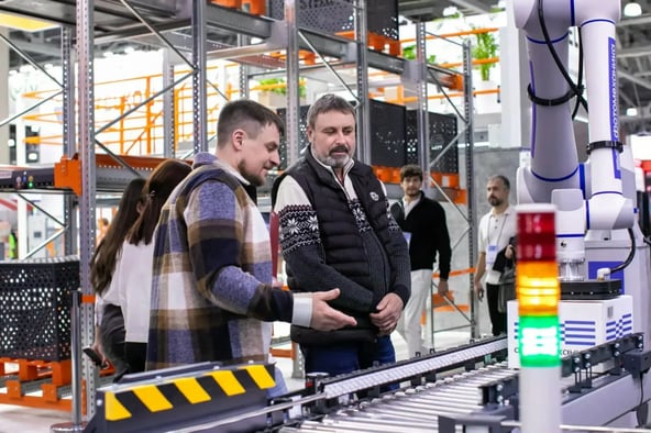 two male workers having a conversation in a factory